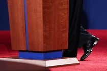 A presidential candidate’s feet at the base of a podium in a presidential debate