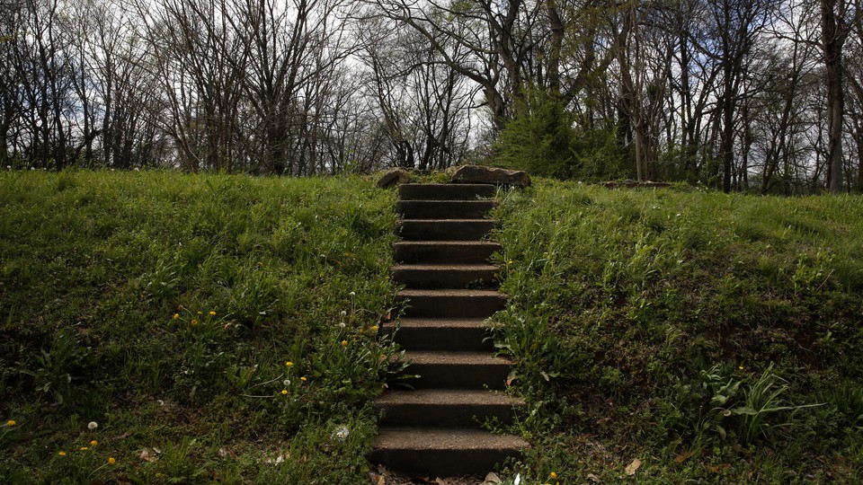 A stairway leads to an empty lot where a house used to stand.