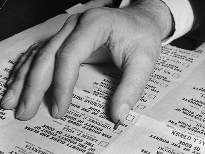 A hand over a ballot