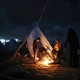A family around a fire in a refugee camp