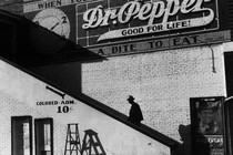 Man climbs stairs leading to segregated cinema.