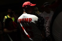 A Trump supporter wears a red hat and a Trump jersey