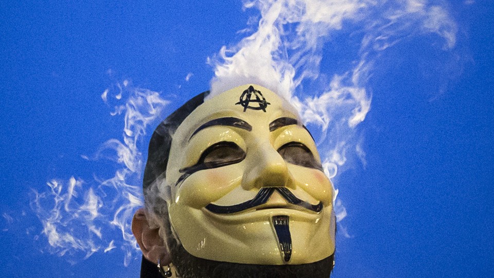 Member of Anonymous movement wearing Guy Fawkes mask