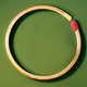 a match bent into a circle, on a green background