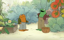 The main characters of "Frog and Toad" in a garden, surrounded by lettuce and tomatoes