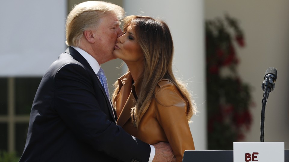 President Donald Trump and Melania Trump kissing on the cheek