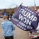 Man carrying a flag that says "Trump Won: Audit Every State."