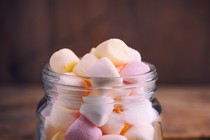 Mini multicolored marshmallows in a glass jar