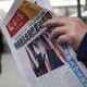A man reads a newspaper with the headline of "U.S. President-elect Donald Trump delivers a mighty shock to America" at a news stand in Beijing.