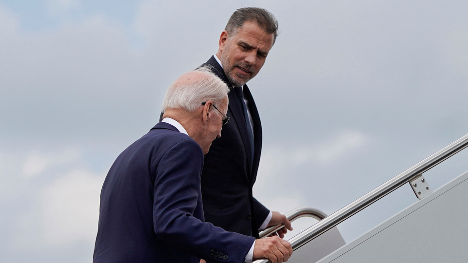 A photograph of Joe and Hunter Biden boarding a plane together