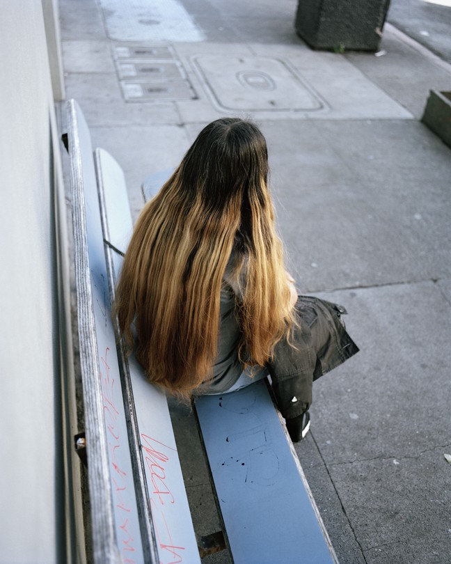 A young girl with her back to the camera