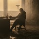 Matt Smith sitting at a table in a gloomy castle in "House of the Dragon"