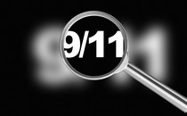 A magnifying glass revealing "9/11"