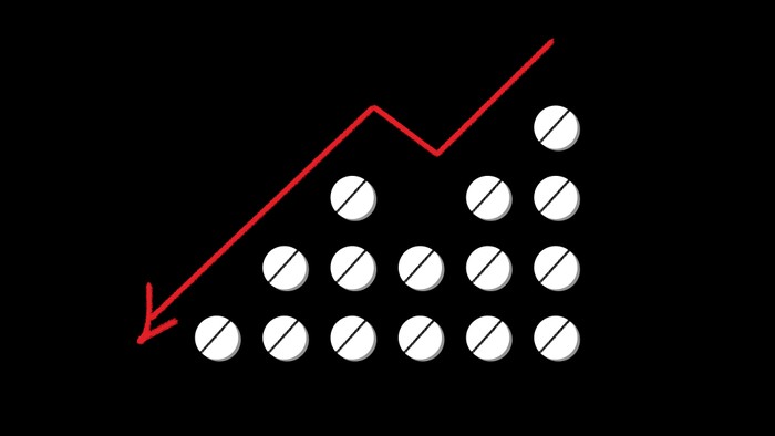 Illustration of pills with a downward-pointing line chart