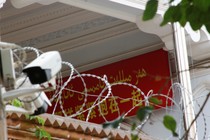 A propaganda banner and a security camera are placed on the walls of a mosque in the Old City in Kashgar, Xinjiang Uighur Autonomous Region, on September 6, 2018