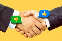 Two people in suits shaking hands. A thumbs up and thumbs down emoji are on top.