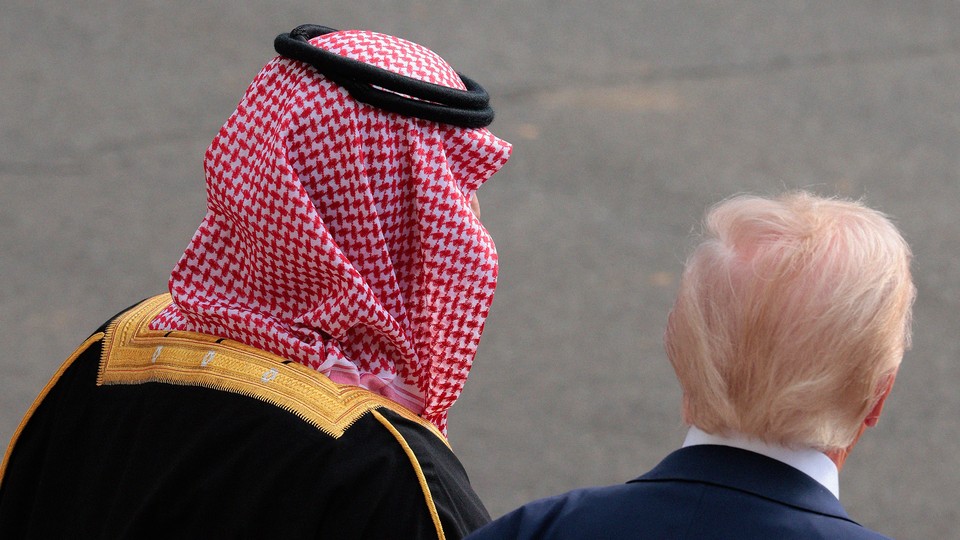 A photo of Mohammed bin Salman and Donald Trump walking, from behind