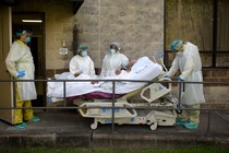 Health-care workers transfer a patient out of the COVID-19 Unit at United Memorial Medical Center in Houston, Texas, during a summer explosion of coronavirus cases.