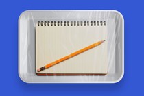 Illustration of a pencil and pad of paper in a sealed microwave-meal container