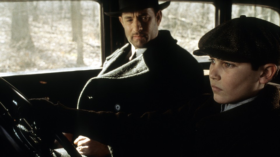 Tom Hanks watches as Tyler Hoechlin drives in a scene from the 2002 film "Road to Perdition."
