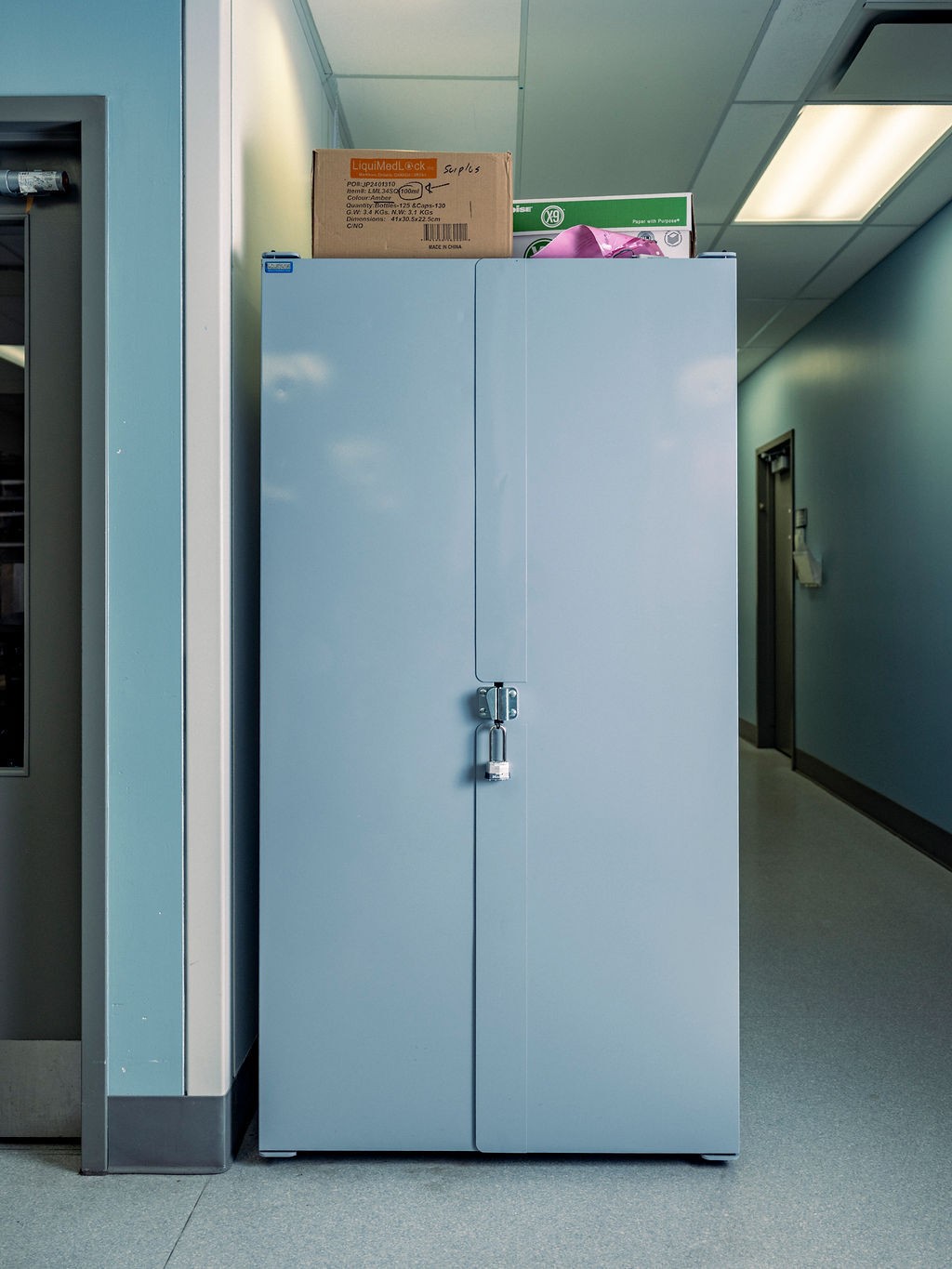 photo of locked tall gray medical cabinet