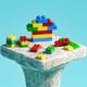 An old stone pillar with Lego blocks on top of it