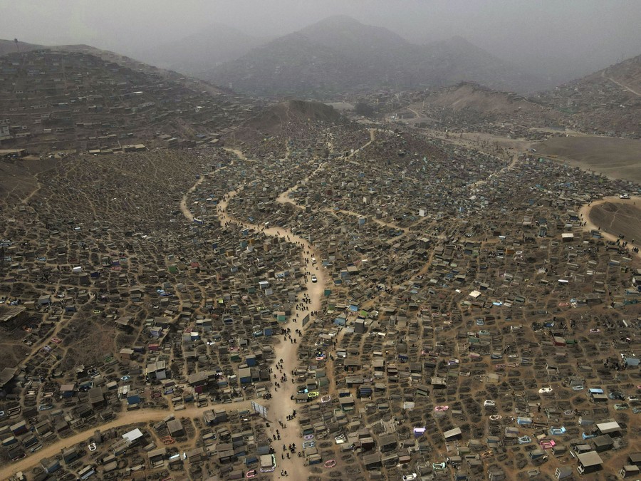 An elevated view of a large cemetery on a barren mountainside.