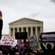 Competing demonstrators displaying anti-abortion and pro-abortion-rights signs at the annual March for Life