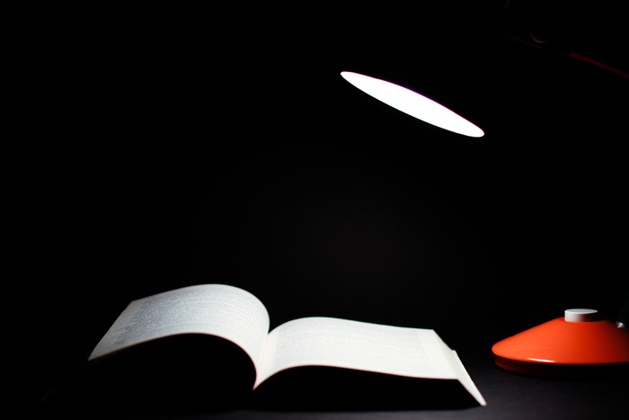 A lamp shining a light on a book