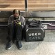 An Uber Eats worker checks his mobile phone in São Paulo.