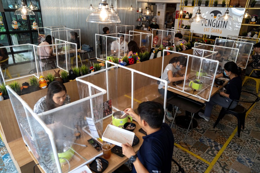 Restaurant with plastic dividers separating all the patrons