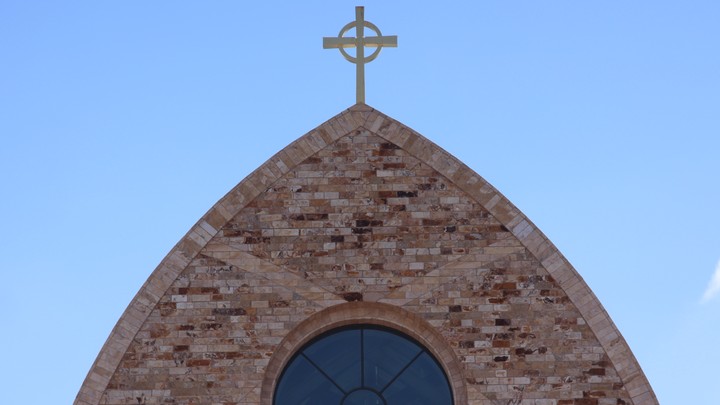 The cross atop Ave Maria Catholic Church, centrally located in Ave Maria, Florida, and across the street from Ave Maria University’s academic buildings