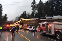 Firefighters and police on the scene of a trail derailment