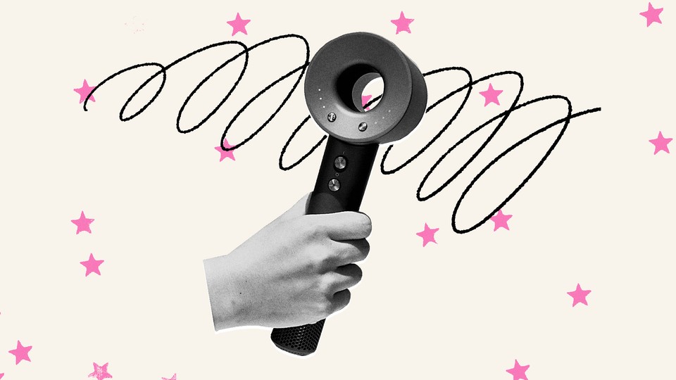 A hand holding a high-tech hairstyling tool