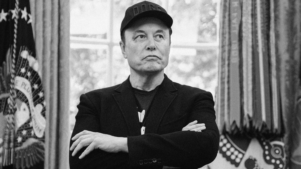 Elon Musk stands with his arms crossed.
