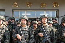 Several rows of soldiers stand holding guns and facing the camera.