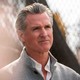 Photo of Gavin Newsom in front of a fence.