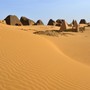 The ruins of several pyramids in the desert sands at Meroë, Sudan
