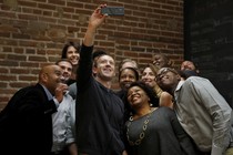 Mark Zuckerberg taking a selfie with a group of people