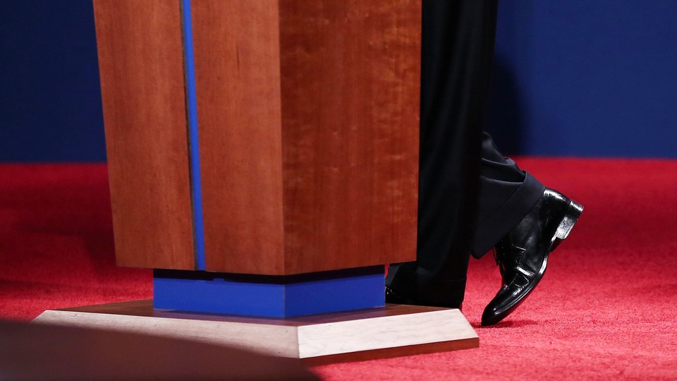A presidential candidate’s feet at the base of a podium in a presidential debate
