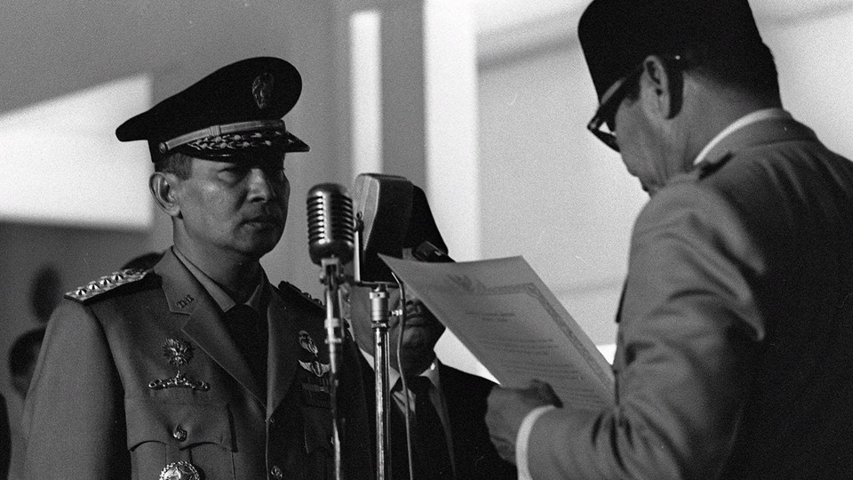 General Suharto being sworn into the Indonesian Cabinet by President Sukarno