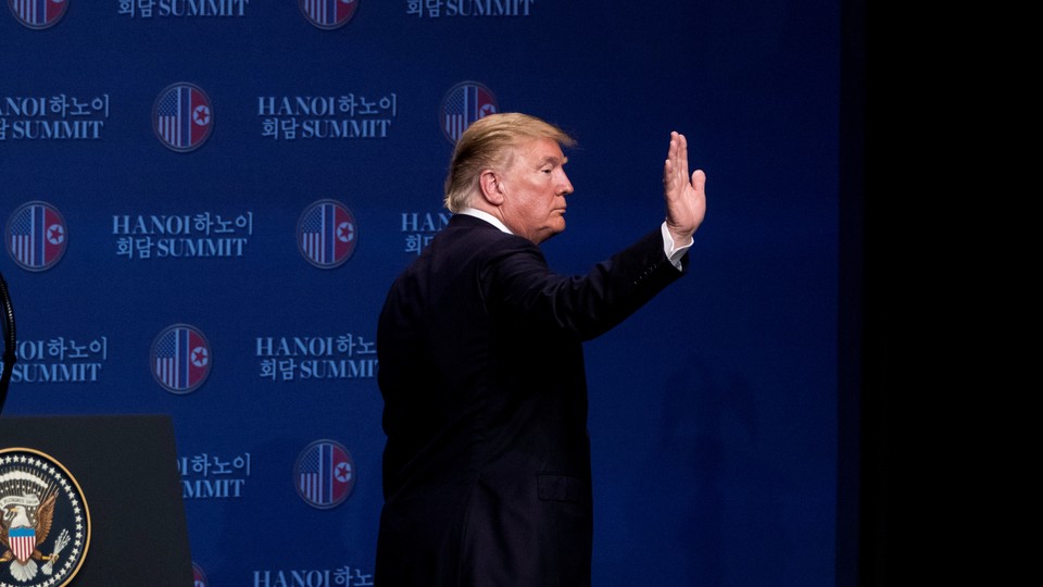 President Trump waves as he leaves a press conference in Hanoi concluding his summit with Kim Jong Un.
