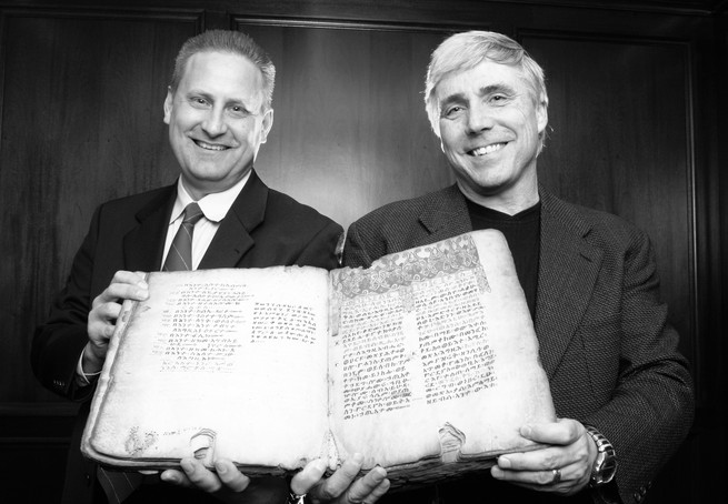 2010 photo: Steve Green and Scott Carroll hold a copy of the 14th-century Ethiopic Gospels