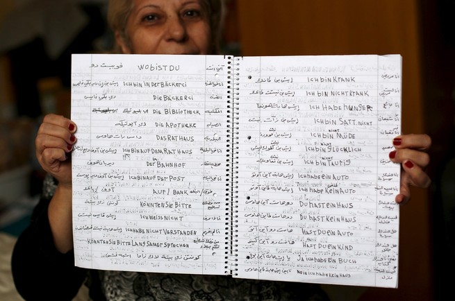 A Syrian woman shows her German learning book in Bautzen, Germany. (Ina Fassbender / Getty)
