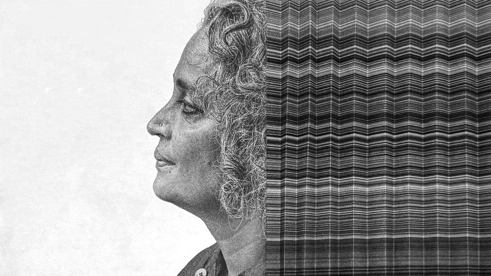 A woman's face in profile with curly gray hair, trailing a series of riffled papers in an illustration.