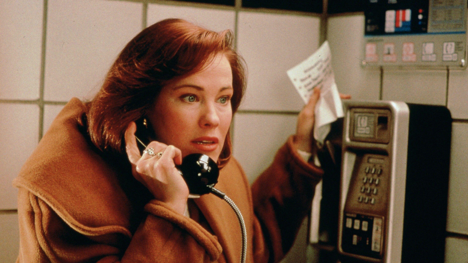 Color film still of Catherine O'Hara at a payphone in "Home Alone."
