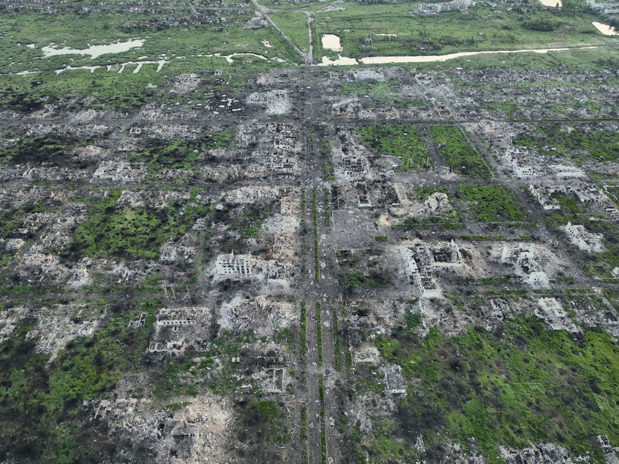 An aerial view of residential buildings razed to the ground by war