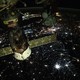 A night view of the Soyuz module docked with the ISS as it passes above Eastern Europe, showing many different-colored city lights