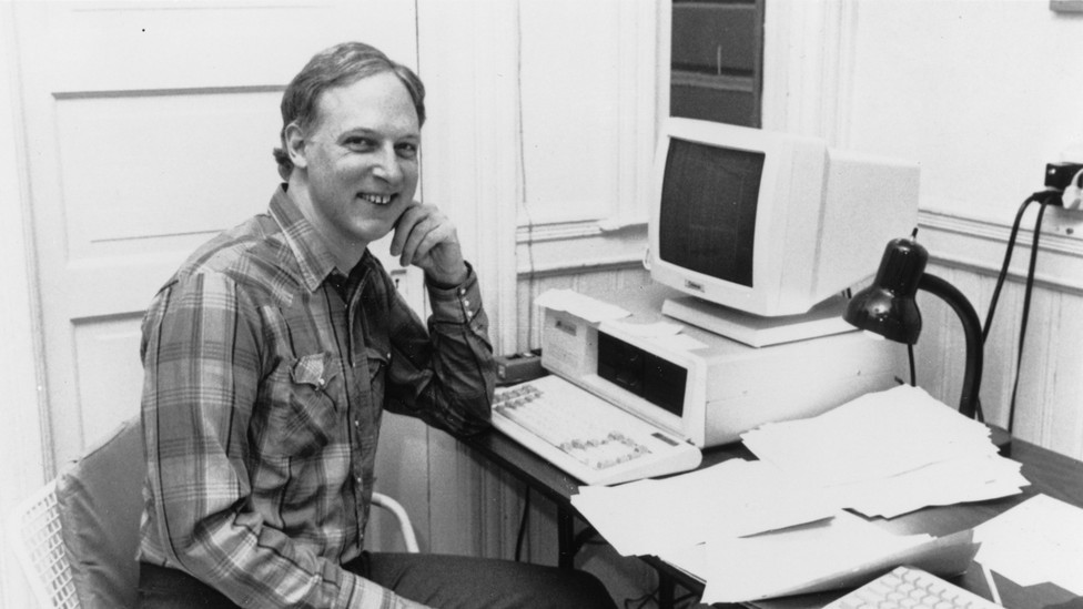 John James sits at a computer in the 80s