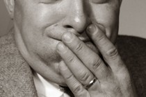 Close-up photograph of someone who appears to be on the verge of throwing up